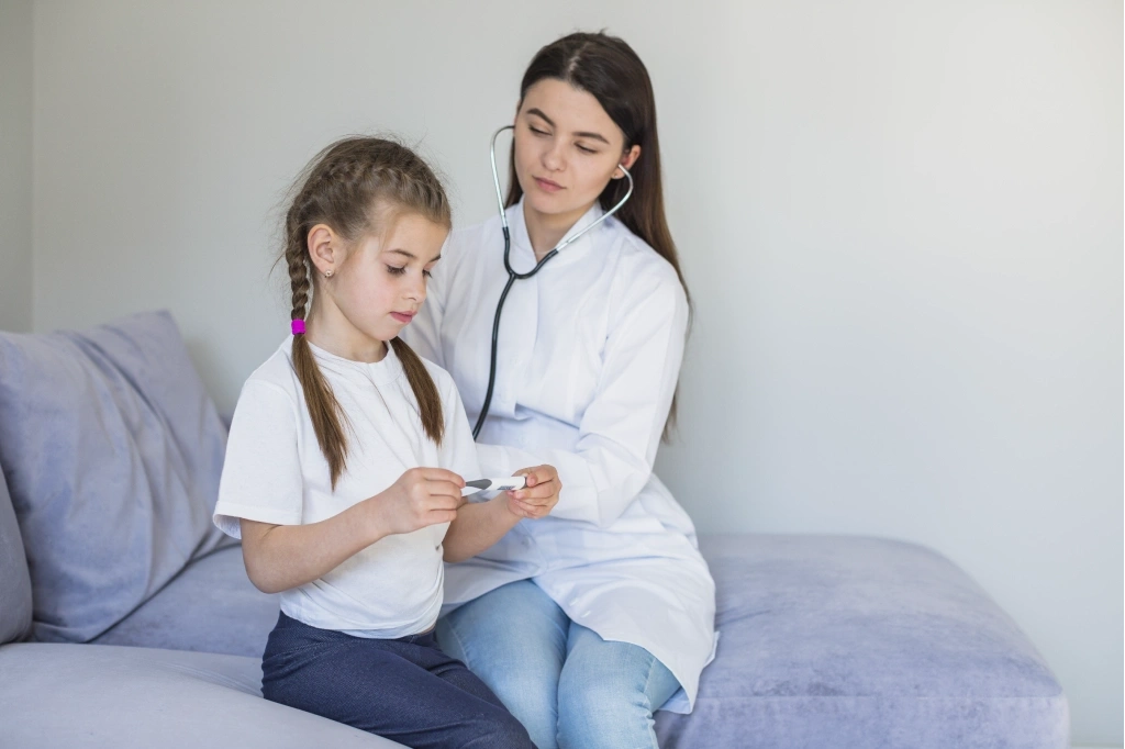 Home doctor assessing a child during an after hours GP visit at home in Australia
