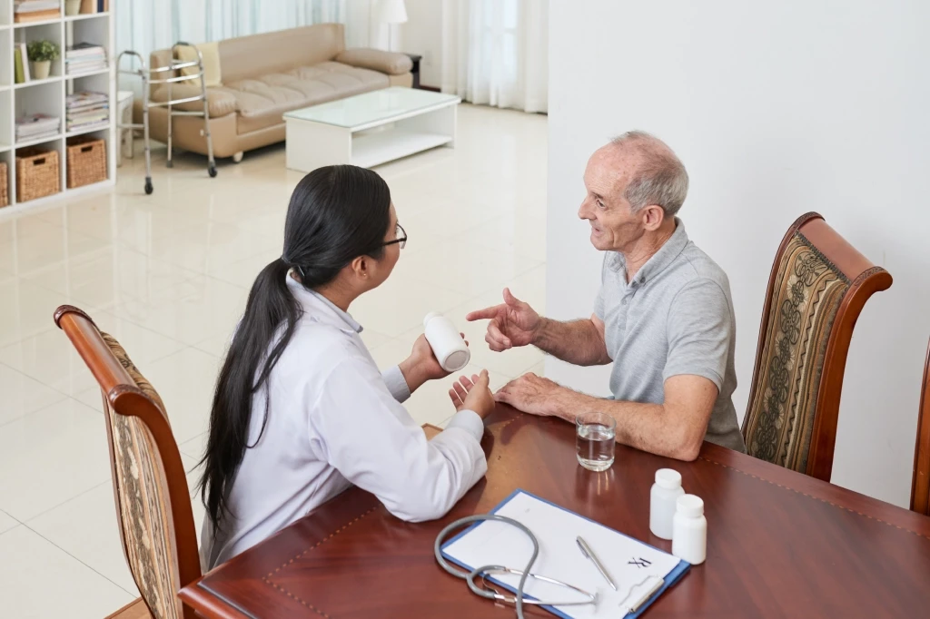 Senior patient receiving after hours GP care at home during a home doctor visit in Australia